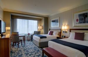 a hotel room with two beds and a television at Loews New Orleans Hotel in New Orleans