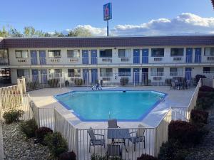 a hotel with a swimming pool in front of a building at Motel 6-Reno, NV - Livestock Events Center in Reno