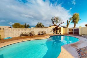 a swimming pool in a yard with a house at Heritage Hideaway in Yuma