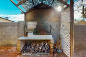 an outdoor grill with a fire in a brick wall at Heritage Hideaway in Yuma