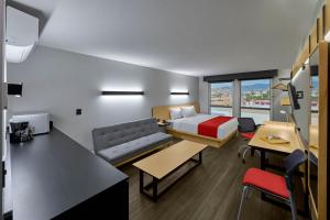 a hotel room with a bed and a couch at City Express by Marriott Ciudad Victoria in Ciudad Victoria +43 photos
