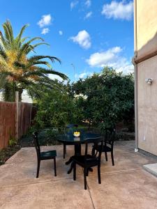 a black table and chairs on a patio at Qazaq Hostel in Los Angeles