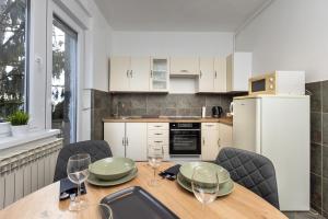 a kitchen with a wooden table with wine glasses on it at Apartman Roza in Zagreb