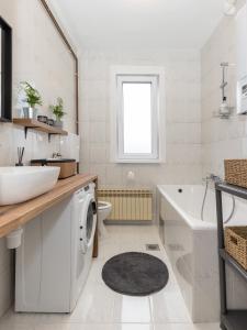a white bathroom with a sink and a washing machine at Apartman Roza in Zagreb +17 photos