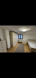 an empty room with a bed and a window at Fine house in Marginea