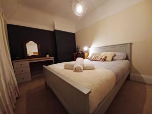 1 dormitorio con 1 cama grande y espejo en The Gemstone Manor en Watford