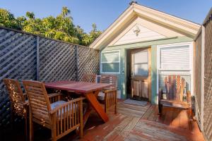 a wooden table and chairs on a wooden deck at Alameda 3BR Penthouse 2 blocks to downtown 3 blocks to the beach AC and 2 free parking spaces in Alameda
