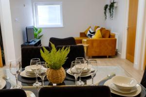 a dining room with a table with plates and wine glasses at The Hidden Fishponds Gem in Bristol