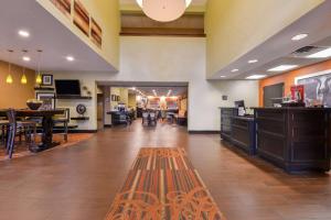 a lobby of a hotel with a tables and chairs at Hampton Inn Elkhart in Elkhart
