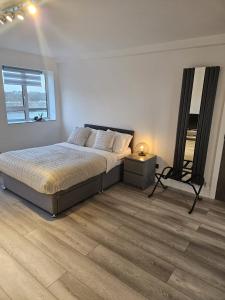 a bedroom with a bed and a mirror in it at Penthouse Studio by Regent's Park/Euston in London