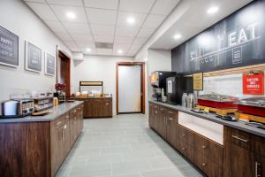 a kitchen with wooden cabinets and a counter top at Hampton Inn Elkins in Elkins