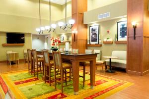 a dining room and living room with a table and chairs at Hampton Inn & Suites Radcliff/Fort Knox in Radcliff