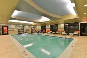 a large swimming pool in the middle of a building at Hampton Inn Corning/Painted Post in Painted Post