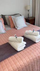 two beds with white towels on top of them at Palermo Soho Apartment Guemes in Buenos Aires +22 photos