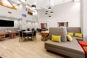 a waiting room with a couch and tables and chairs at Hampton Inn & Suites Fairbanks in Fairbanks