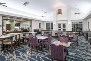 a dining room with tables and purple chairs at Homewood Suites by Hilton Fresno Airport/Clovis in Clovis