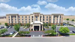 a large building with a parking lot in front of it at Hampton Inn & Suites Madera in Madera