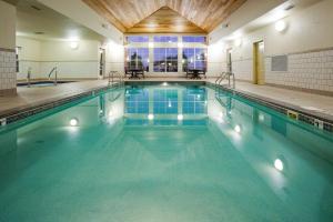 a swimming pool with blue water in a building at Homewood Suites by Hilton Sioux Falls in Sioux Falls