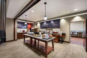 a restaurant with a table with food on it at Hampton Inn and Suites Fredericksburg in Fredericksburg