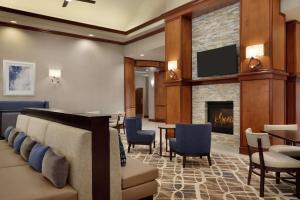 a lobby with a waiting room with a fireplace at Homewood Suites by Hilton Fort Smith in Massard