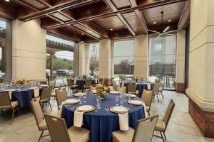 a banquet hall with blue tables and chairs at Homewood Suites by Hilton Fort Smith in Massard