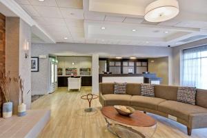 a living room with a couch and a table at Homewood Suites Fredericksburg in Fredericksburg