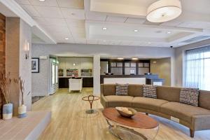 a living room with a couch and a table at Homewood Suites Fredericksburg in Fredericksburg