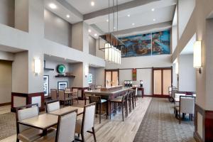 a dining room with tables and chairs in a restaurant at Hampton Inn & Suites Ft Worth-Burleson in Burleson