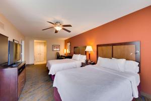 a hotel room with two beds and a flat screen tv at Homewood Suites by Hilton Fort Worth Medical Center in Fort Worth