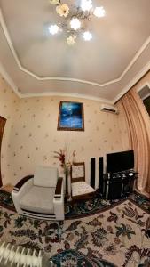 a living room with a couch and a chair at Fountain Square Apartment in Baku