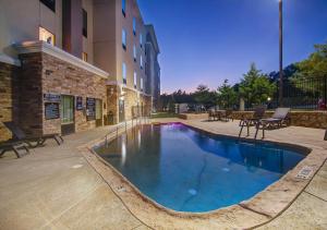 a swimming pool in front of a building at Hampton Inn and Suites Trophy Club - Fort Worth North in Trophy Club