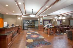 a lobby with a bar and a restaurant at Hampton Inn Siloam Springs in Siloam Springs