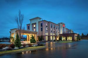 a large building in a parking lot at night at Hampton Inn & Suites Spokane Valley in Spokane Valley