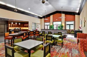 a restaurant with tables and chairs in a room at Homewood Suites by Hilton- Longview in Longview