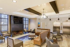 a waiting area with a fireplace in a waiting room at SpringHill Suites by Marriott Topeka Southwest in Topeka