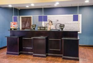 a woman standing at a counter in a store at Hampton Inn Galax in Galax