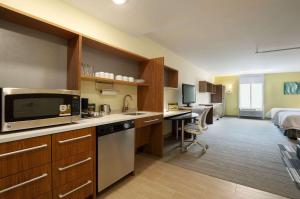 a hotel room with a kitchen and a bed at Home2 Suites by Hilton Biloxi/North/D'Iberville in Biloxi