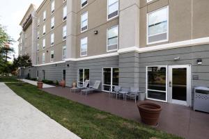 a building with a patio in front of it at Hampton Inn & Suites Greensboro/Coliseum Area in Greensboro