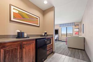 a kitchen with a black dishwasher in a room at Hampton Inn & Suites Greeley in Greeley