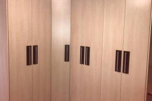 four wooden cabinets with black handles in a room at Casa próximo ao Boticário in São José dos Pinhais +6 photos