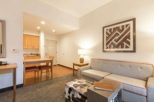 a living room with a couch and a kitchen at Homewood Suites by Hilton at Carolina Point - Greenville in Greenville