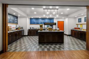 a large kitchen with wooden cabinets and a counter top at Hampton Inn & Suites Schererville in Schererville