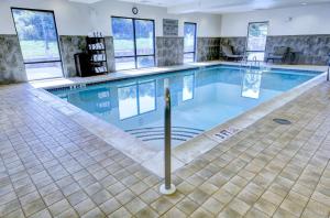 a swimming pool in a hotel with a tile floor at Hampton Inn & Suites Harrisburg in Harrisburg