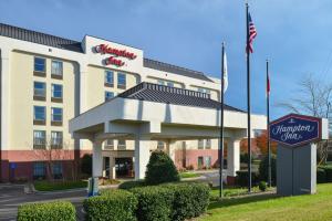 a hotel building with a sign in front of it at Hampton Inn Henderson in Henderson