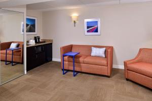 a living room with a couch and a chair at Hampton Inn Henderson in Henderson