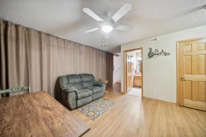 a living room with a chair and a ceiling fan at 2-Bedroom Loft Suite 14 minutes from Airport and Mall of America in Inver Grove Heights