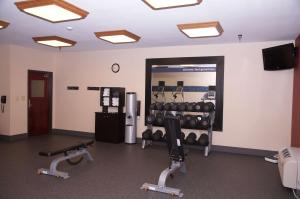 a room with a gym with weights and a mirror at Hampton Inn & Suites Hobbs in Hobbs