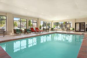 a large swimming pool with chairs and a table at Hampton Inn & Suites Houston-Cypress Station in Westfield