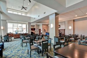 a restaurant with tables and chairs in a room at Homewood Suites by Hilton Houston Near the Galleria in Houston