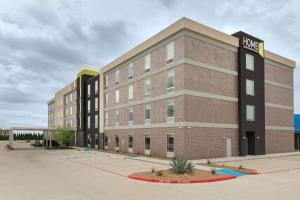 a large brick building with a hotel sign on it at Home2 Suites by Hilton Houston Katy in Katy